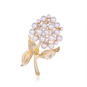 Detail of flower brooch with white imitation pearls and rhinestones on gold metal stem
