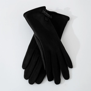 Close-up of black suede gloves for women featuring a delicate bow tie decoration