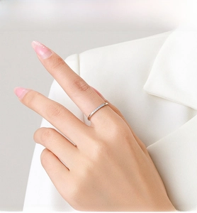 Close-up of S925 silver ring featuring micro-pave light blue zircons on model hand