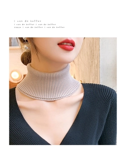 Close-up of the apricot knitted texture on the cashmere turtle neck faux collar wrap