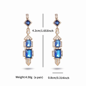 Detailed view of luxury gold earrings with blue geometric stones and dimensions