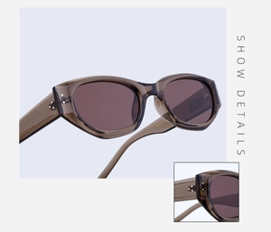 Detail showing amber cat-eye sunglasses with silver rivet accents on the temple hinge