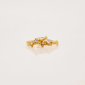 Detailed view of 18K gold plated lava textured earrings with shimmering white zircons