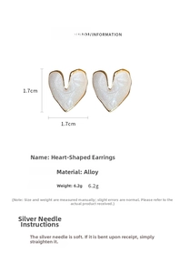Detail view of cream heart earrings with gold trim and 1.7cm size specification