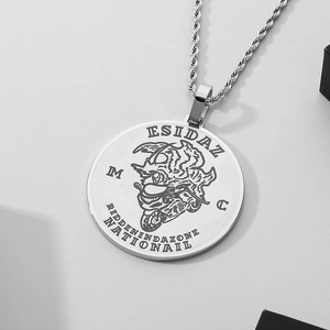 Macro detail of silver titanium steel necklace with engraved motorcycle skull pendant