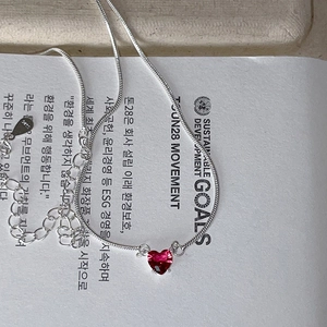Detail shot of heart-shaped red gemstone necklace with S925 sterling silver stamp