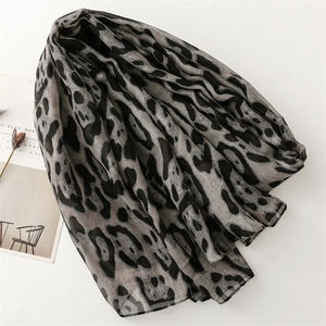 Close-up of lightweight leopard print cotton linen scarf with gray and black patterns