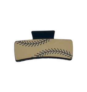 Close-up of rectangular baseball patterned hair clip with cream finish and black stitching