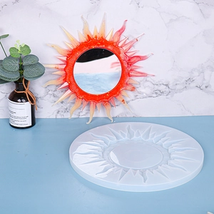 Macro view of sunburst mirror silicone mold and finished orange resin wall decor