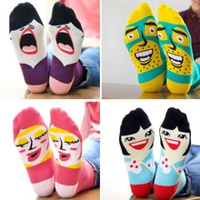 Detail of four pairs of cotton socks with unique colorful cartoon face patterns on soles