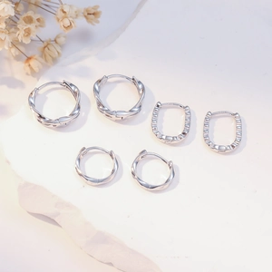 Detail shot of three pairs of S925 sterling silver hoop earrings with textured finish