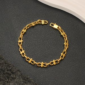 Detailed view of gold T-link chain bracelet featuring a polished rectangular clasp