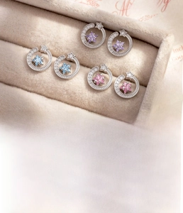 Detailed view of titanium steel star stud earrings with pink, purple, and blue zircons