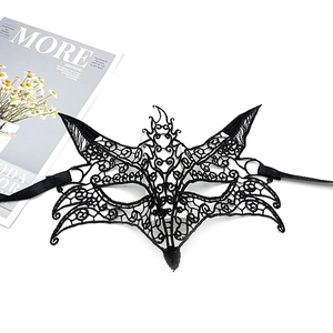 Detail of elegant black lace masquerade mask with satin ribbons on a white background