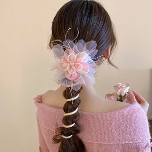 Detail shot of the sweet floral ponytail hair accessory with crystal accents and spiral tie.