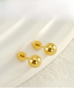 Macro shot of polished gold ball stud earrings with a secure screw-back design