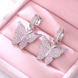 Sparkling silver butterfly earrings with pink rhinestones inside a pink jewelry box