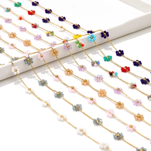 Colorful floral bead necklaces with golden stainless steel chain on display