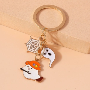 Detail of Halloween keychain showing spider web, ghost, and witch pendants with gold plating