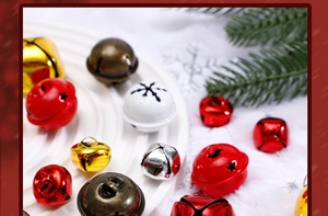 Close-up of colorful metal Christmas bells in red, gold and white for festive crafts