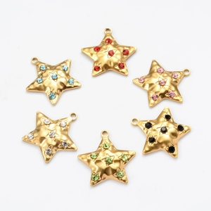 Detail view of 6 gold star-shaped pendants with colorful rhinestones on a white background