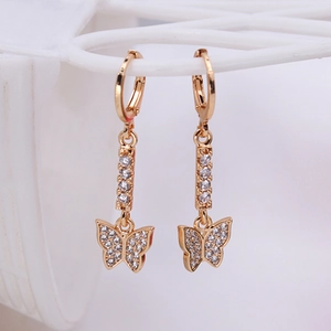 Elegant gold butterfly dangle earrings with clear zircon crystals on white grid stand