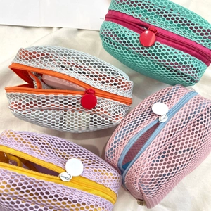 Close-up of colorful mini mesh storage bags with round zippers in various vibrant colors