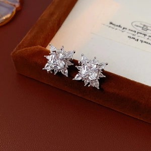 Close-up of snowflake zircon ear cuff with sparkling crystals on dark velvet jewelry box