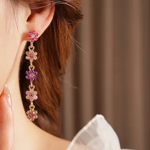 Elegant drop earrings featuring five gradient colorful rhinestone flowers on gold plating