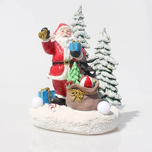 Detailed view of resin Santa Claus figurine with snowy pine trees and gift bag decor