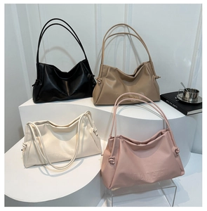 Group display of chic large tote bags in four colors with side drawstring knot details