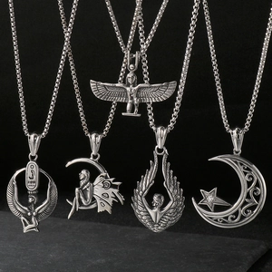 Macro detail of five vintage silver stainless steel wing and Egyptian deity pendants