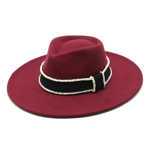 Detail of burgundy wool fedora with pearl-embellished black grosgrain ribbon trim