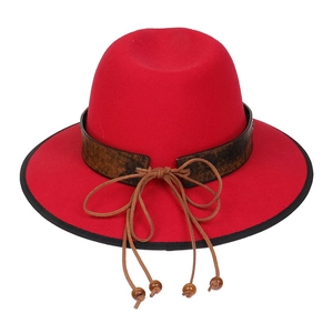 Close-up of red wide brim fedora with vintage brown leather belt and wooden bead tassels