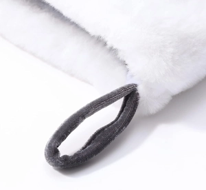 Close-up of gray velvet loop and soft white faux fur texture on a Christmas stocking