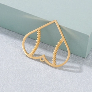 Gold heart pendant with baseball stitching texture on a minimalist metal charm