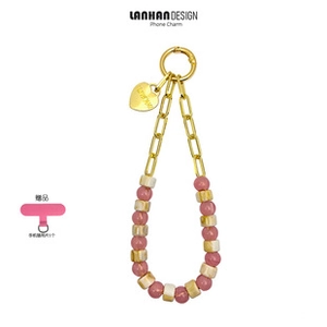 Detail of pink and marble beaded phone strap with gold heart charm and lobster clasp