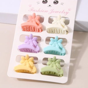 Detail of 6-piece matte flower hair clips in various pastel colors on a display card