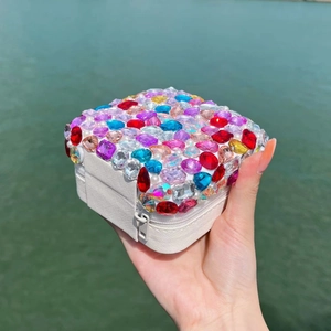 Portable white jewelry box with colorful rhinestones and pearls for rings and necklaces