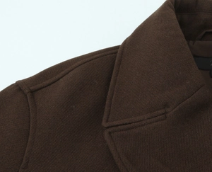 Close-up of a dark brown wool coat collar with detailed stitching and soft fabric texture