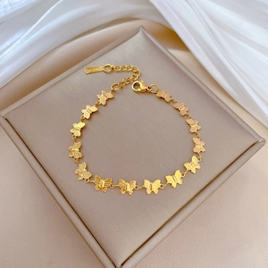 Minimalist gold butterfly chain bracelet in titanium steel with fine textured detailing