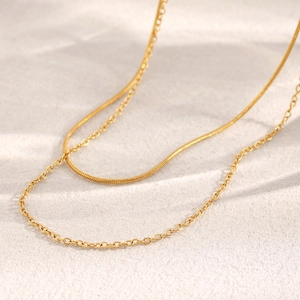Close-up of double-layer 18K gold plated necklace with snake and O-chain detail