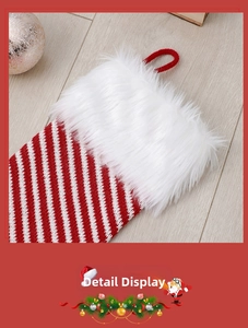 Close-up of knit Christmas stocking with red and white stripes and plush faux fur cuff