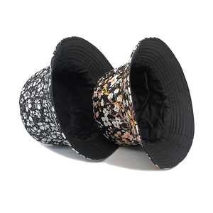Reversible floral bucket hat for women in black and white and colorful flower patterns