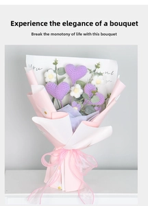 Detailed view of hand-knitted purple heart and daisy bouquet in pink wrapping