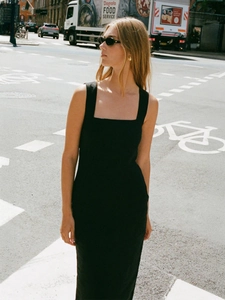 Detail of a slim fit black square neck midi dress made of cotton linen blend