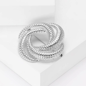 Detailed view of silver intertwined textured rings in a nautical knot brooch design