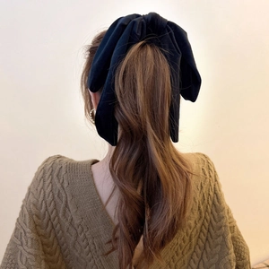 French vintage oversized black velvet bow hair scrunchie shown from a back view