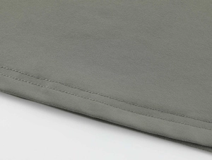 Detailed view of grey tank top hem featuring professional double-needle stitching quality