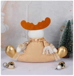 Detail of Christmas reindeer plush with golden sequins, orange antlers and metallic feet